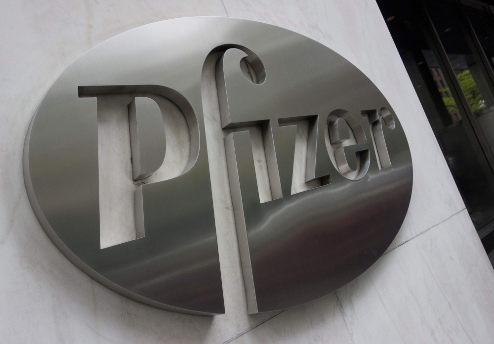 In this file photo the Pfizer company logo is seen in front of Pfizer’s headquarters April 27, 2016 in New York. Pfizer reported a drop in second-quarter profits on July 28, 2020, but lifted its full-year forecast on expectations that medical activities c