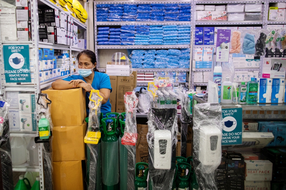 A vendor waits for customers inside a store selling medical and personal protective equipment, amid the coronavirus disease (COVID-19) outbreak, in Manila, Philippines August 10, 2020. REUTERS/Eloisa Lopez