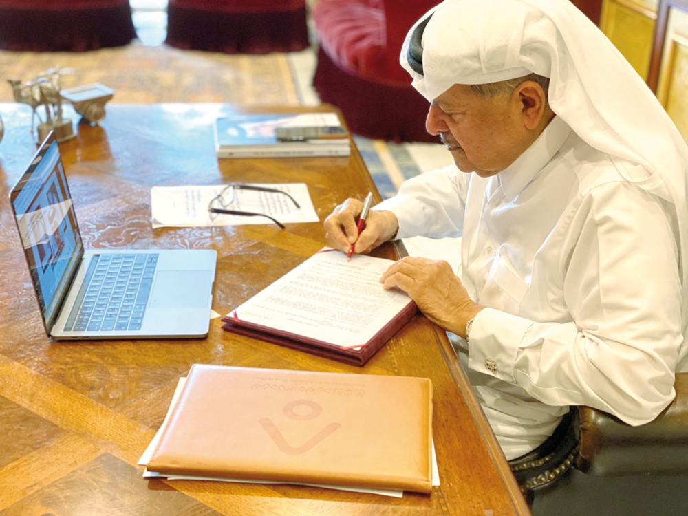 Sheikh Faisal bin Qassim Al Thani, Chairman of Aamal Company, signing the agreement of the contract in Doha, yesterday. 