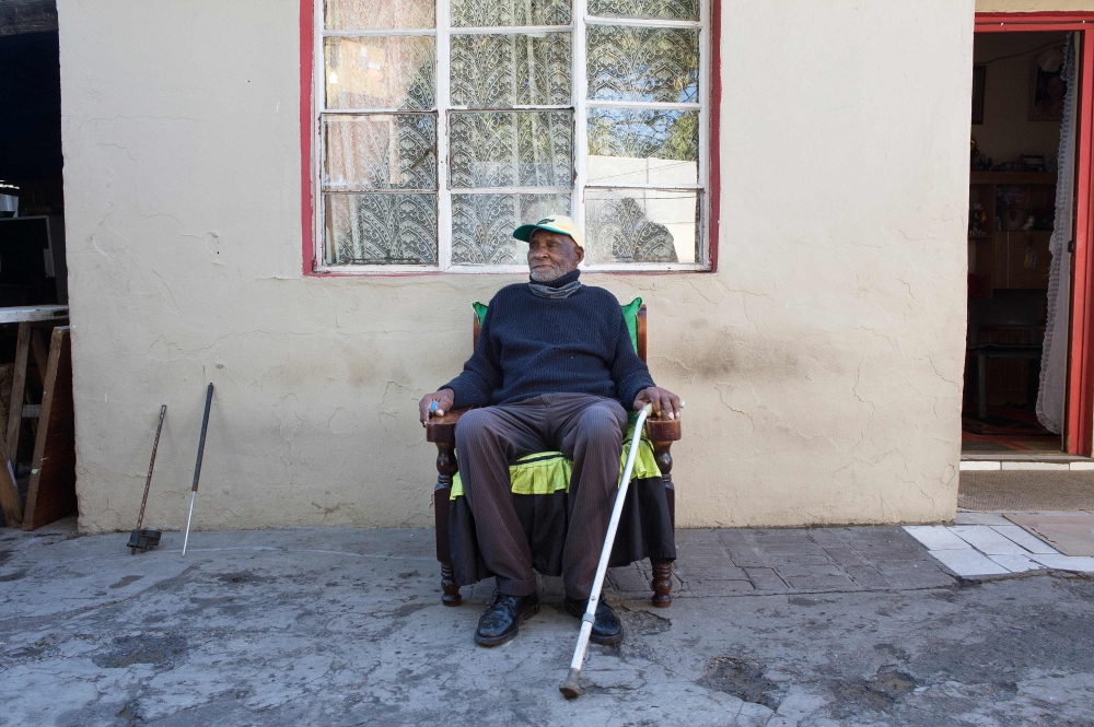 Fredie Blom poses for a portrait while celebrating his 116th birthday at his home in Delft, near Cape Town. (AFP / RODGER BOSCH)