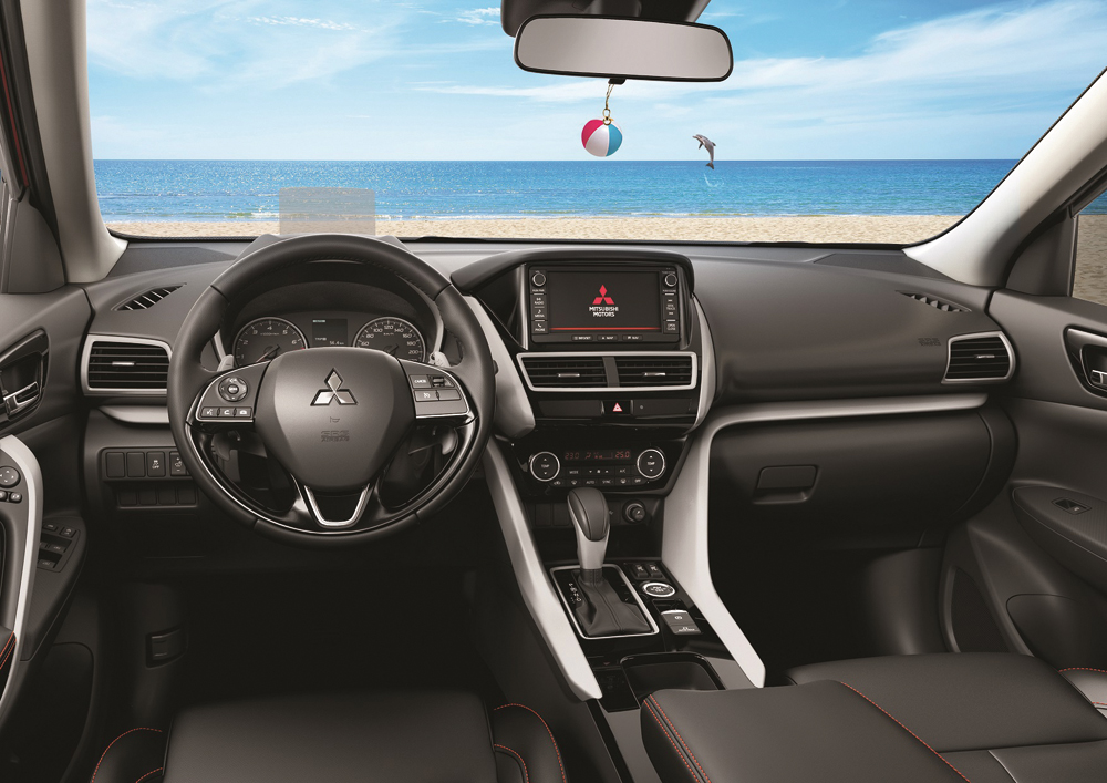 A view of the interior and dashboard of a Mitsubishi car.