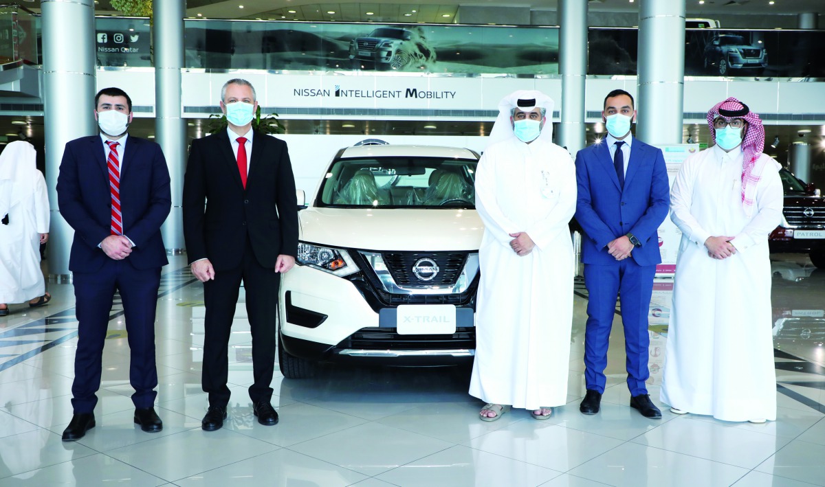 Representatives of Qatar Cancer Society and Saleh Al Hamad Al Mana Co during handover of the vehicle. 