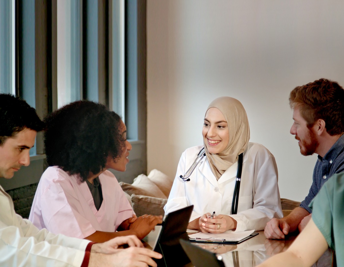 A female doctor leading a multi-ethnic medical team.