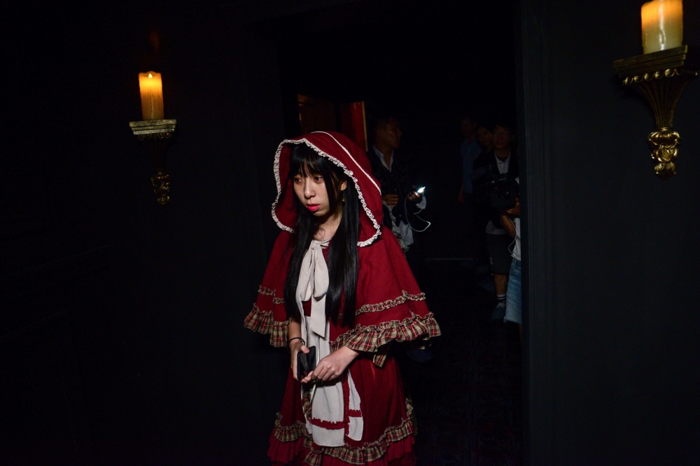 This photo taken on August 13, 2020 shows a player taking part in the live action role-play (LARP) murder mystery game 