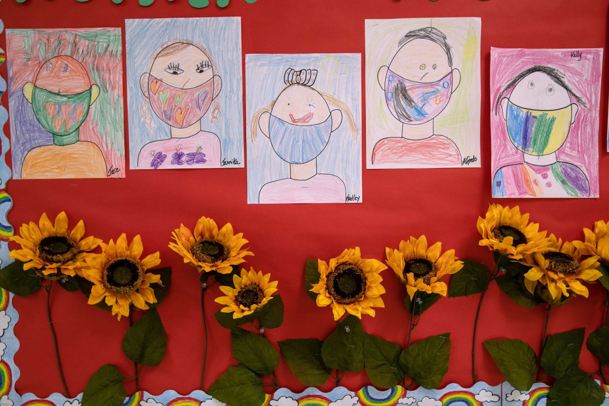 STAMFORD, CONNECTICUT - SEPTEMBER 16: Drawings of children wearing masks adorn a hallway at Stark Elementary School on September 16, 2020 in Stamford, Connecticut. John Moore/AFP