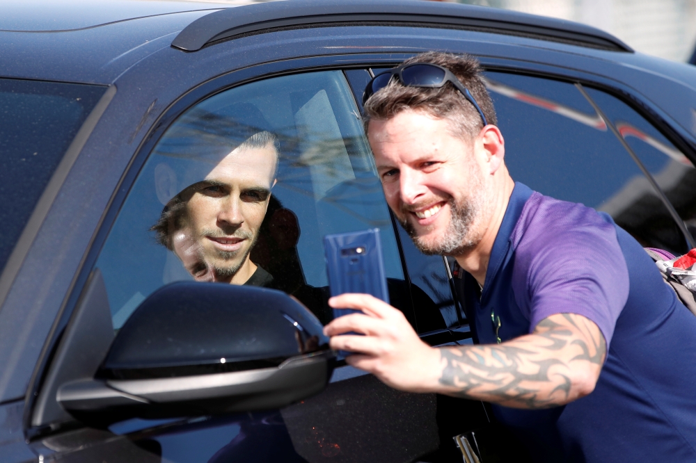 Gareth Bale poses for a photo with a fan as he leaves London Luton Airport. Gareth Bale is expected to complete his return to Tottenham Hotspur. Reuters/Paul Childs
