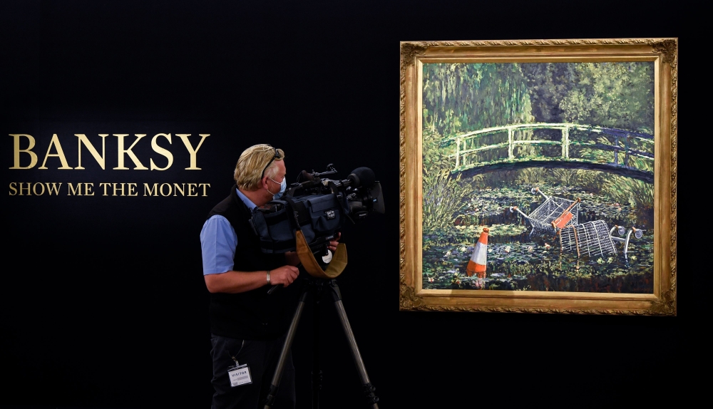 A television camera operator films an artwork entitled 