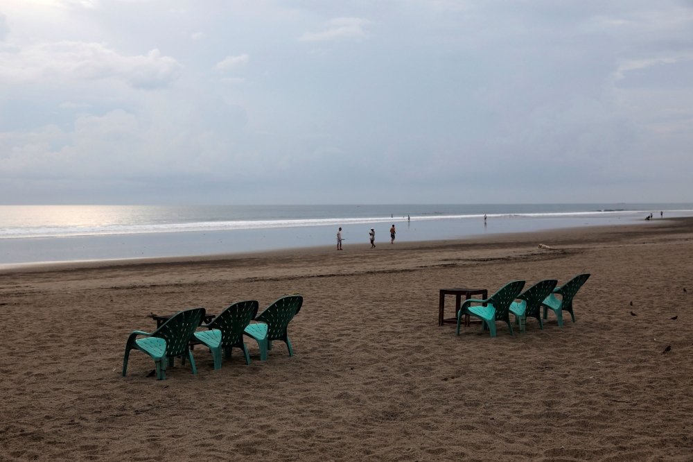 FILE PHOTO: Empty chairs are seen at Seminyak beach amid the spread of coronavirus disease (COVID-19) in Bali, Indonesia, March 23, 2020. REUTERS/Nyimas Laula/File Photo