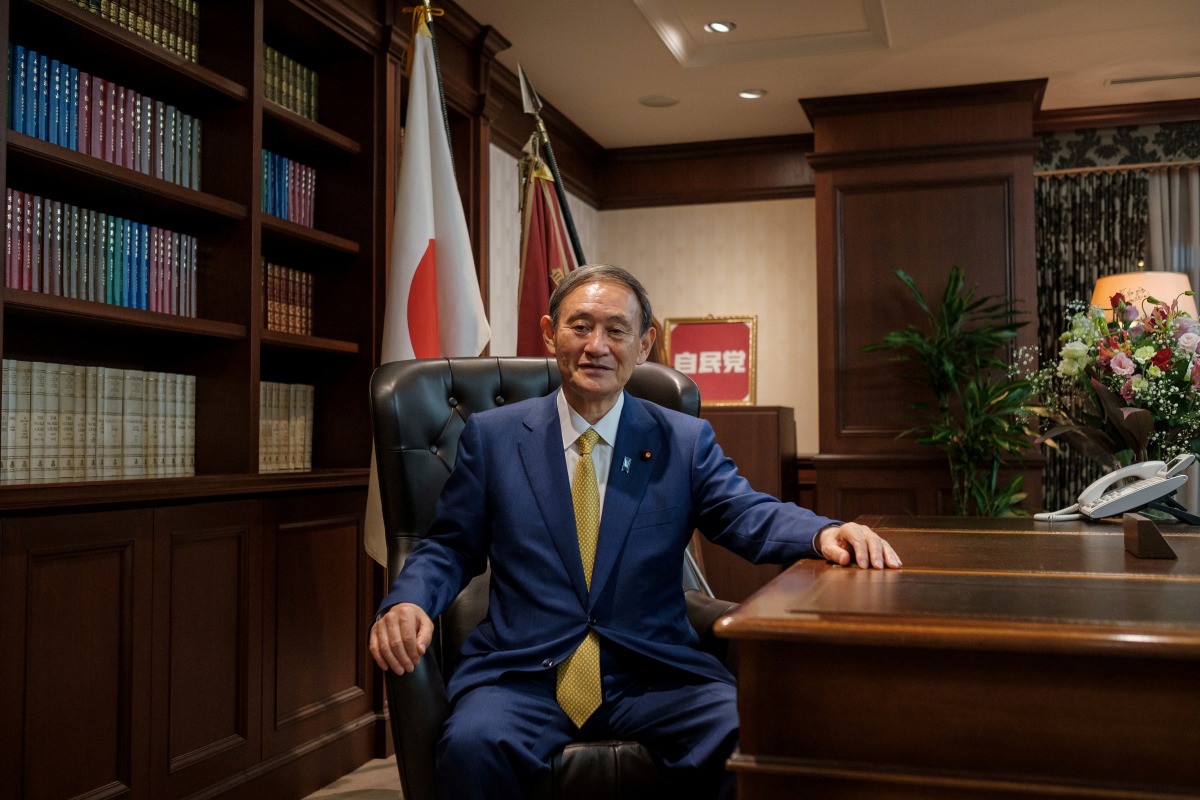 FILE PHOTO: Japanese Chief Cabinet Secretary Yoshihide Suga poses for a picture following his press conference at LDP (Liberal Democratic Party) headquarters, in Tokyo, Japan September 14, 2020. Nicolas Datiche/Pool via REUTERS/File Photo
