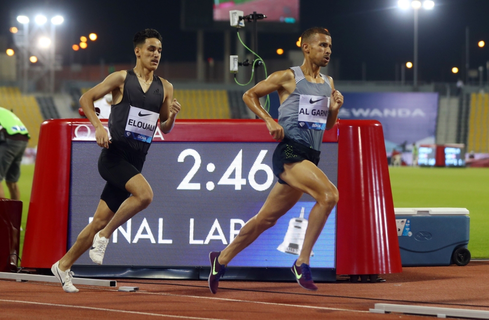 Morocco's Ilyass El Ouali and Qatar's Mohamed Al Garni in action during the men's 1500 metres Reuters/Ibraheem Al Omari