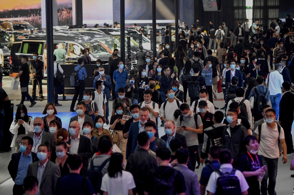 People attend the Beijing Auto Show in Beijing on September 26, 2020. / AFP / Noel CELIS