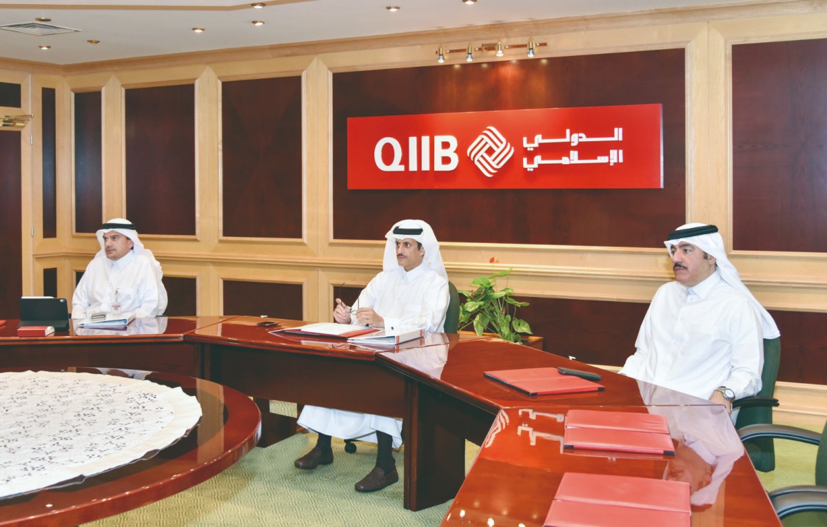 Sheikh Dr. Khalid bin Thani bin Abdullah Al Thani (centre), Umnia Bank Chairman, and Chairman of the Board of Directors and Managing Director at QIIB, and other senior officials of the Group chairing the board meeting for Umnia Bank recently. 