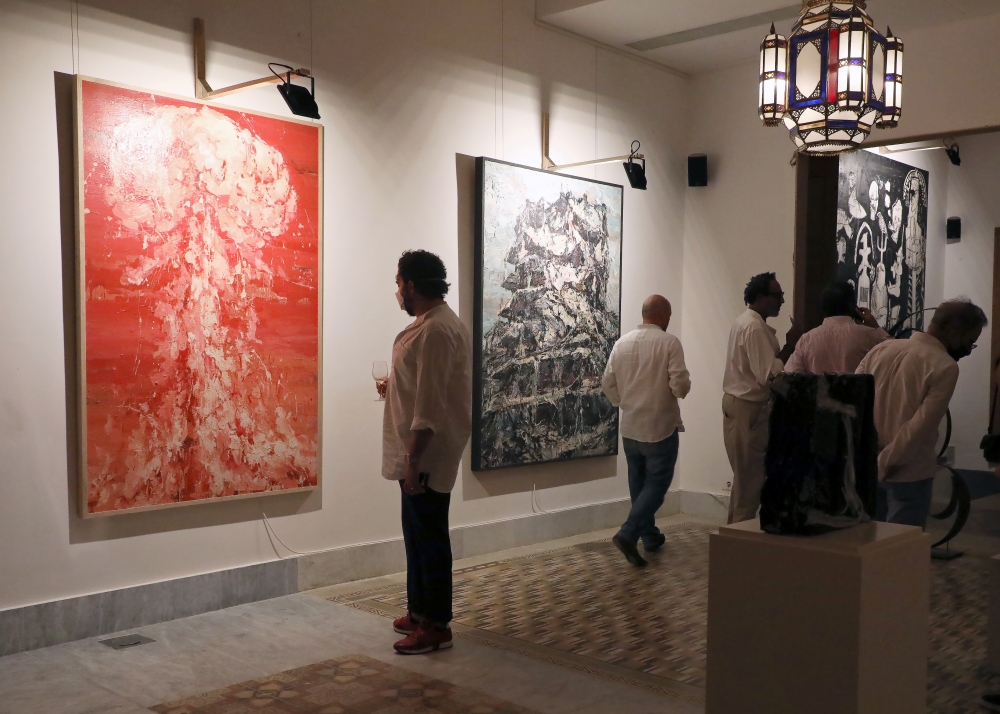 Visitors look at artworks by Ayman Baalbaki and Tagreed Darghouth during a collective exhibition entitled 
