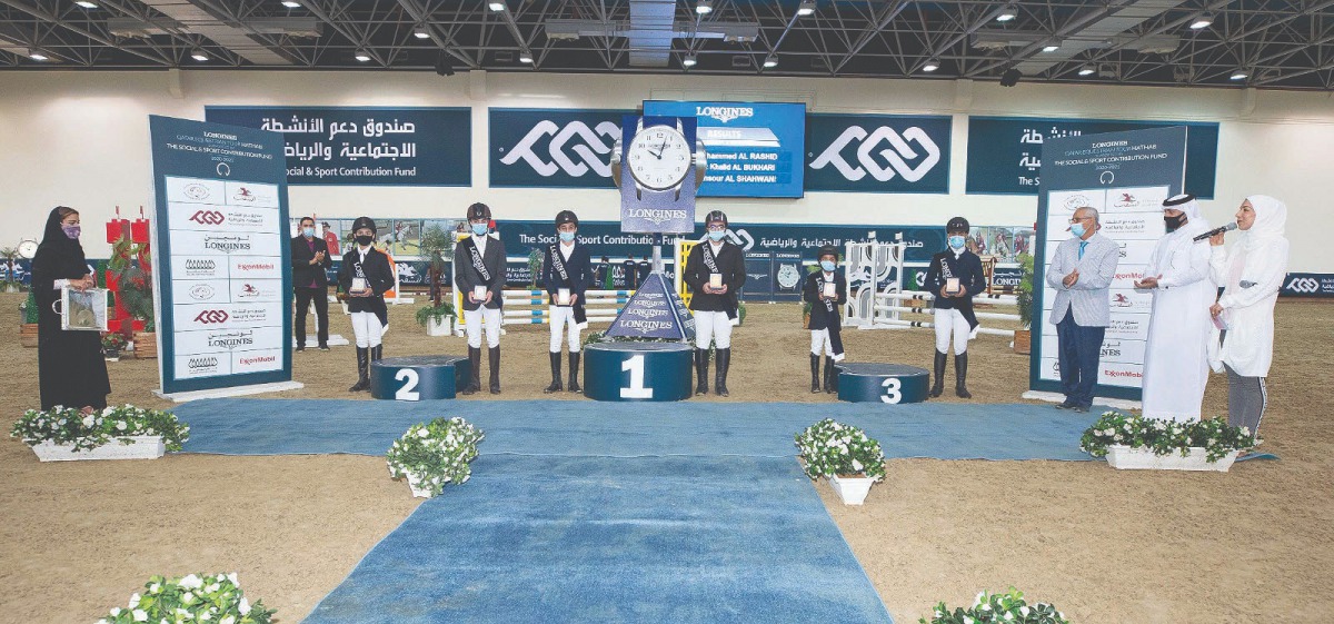 Officials are seen with winners in the Futures Riders Competition at QEF's Indoor Arena yesterday.
