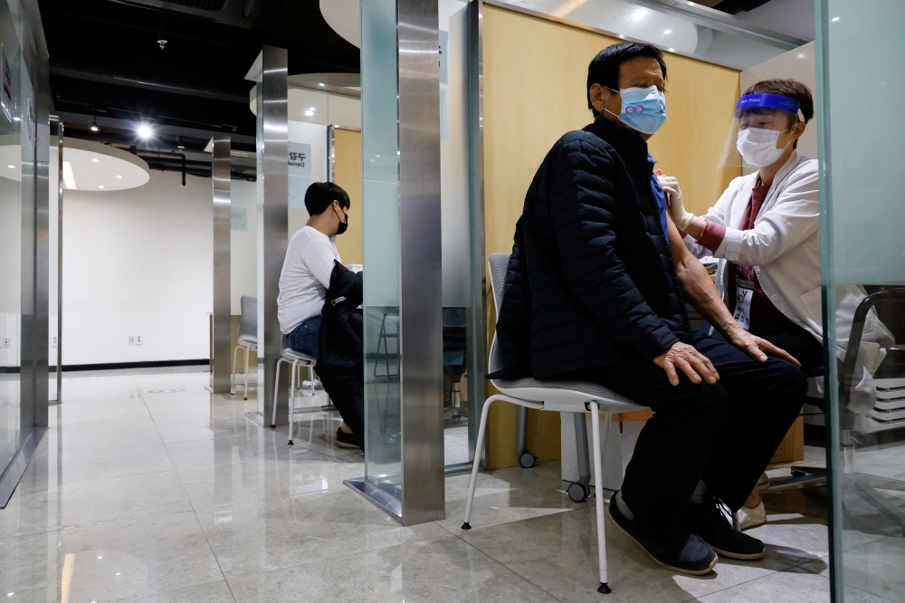 A man gets an influenza vaccine at a branch of the Korea Association of Health Promotion in Seoul, South Korea, October 23, 2020. REUTERS/Kim Hong-Ji
