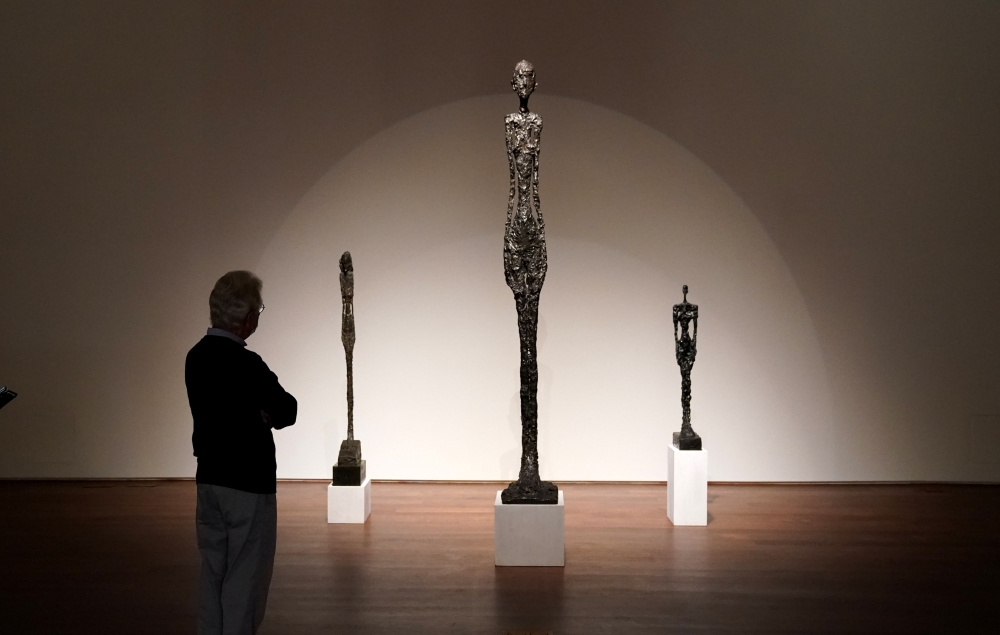 A person looks at Alberto Giacometti's 