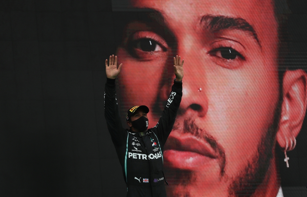 October 25, 2020 Mercedes' Lewis Hamilton celebrates winning the race on the podium Pool via REUTERS/Jose Sena Goulao