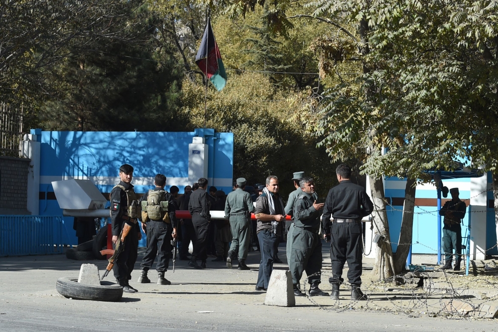 Policemen stand guard at an entrance gate of the Kabul University in Kabul on November 2, 2020. AFP / WAKIL KOHSAR