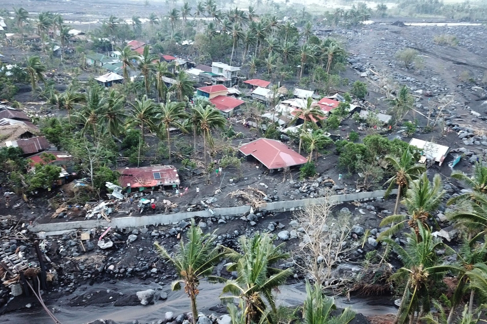 This aerial photo taken on November 2, 2020, shows houses buried by boulders and lahar washed from the slopes of nearby Mayon Volcano in Guinobatan town, Albay province, south of Manila, after super Typhoon Goni made landfall in the Philippines on Novembe