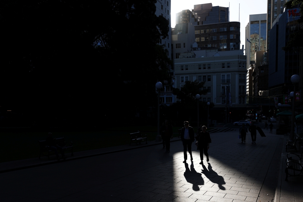 People walk through a park in the city centre of Sydney, Australia, November 9, 2020. REUTERS/Loren Elliott