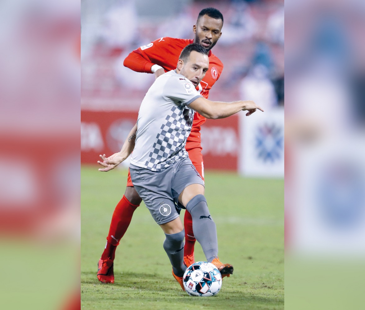 Al Sadd's Santi Cazorla vies for the ball with an Al Arabi player during yesterday's match.