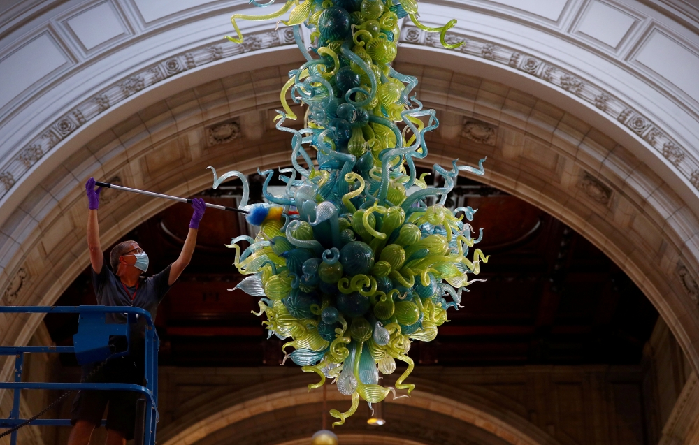 File photo: A museum technician cleans the V&A Rotunda Chandelier by Dale Chihuly during preparations to reopen the Victoria & Albert (V&A) Museum, after the outbreak of the coronavirus disease (COVID-19) caused its closure, in London, Britain, August 4, 