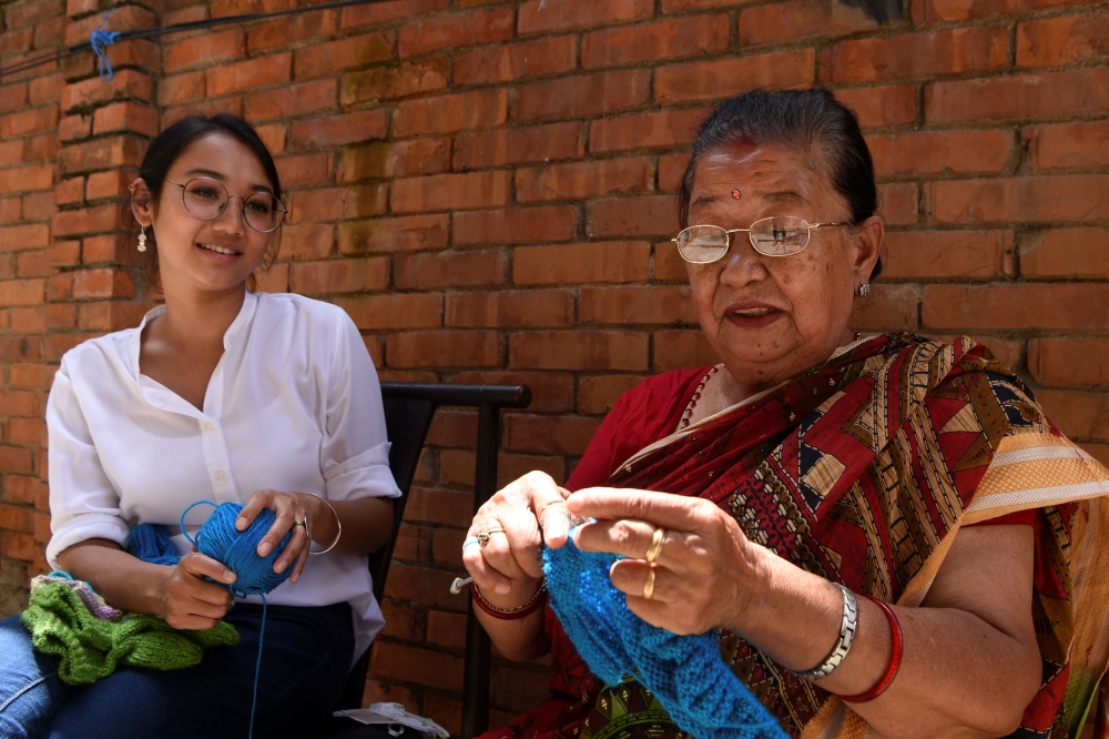 In this picture taken on August 6, 2020, business woman Lorina Sthapit (L) looks at her grandmother Champa Devi Tuladhar during an interview with AFP in Kathmandu. AFP / Prakash Mathema 