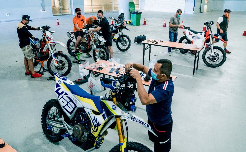 Riders are seen tending to their bikes on the second day of the installation of navigation kits for the motorcycle category as part of the Qatar National Baja events. 