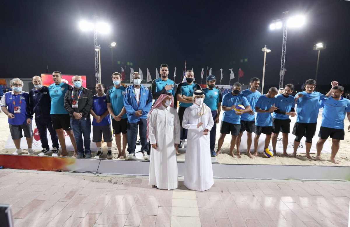 Qatar Olympic Committee (QOC) Secretary-General Jassim Rashid Al Buenain posing for a photograph with the beach volleyball players and officials during the opening ceremony of the inaugural QOC Beach Games at Aspire Park, yesterday. 