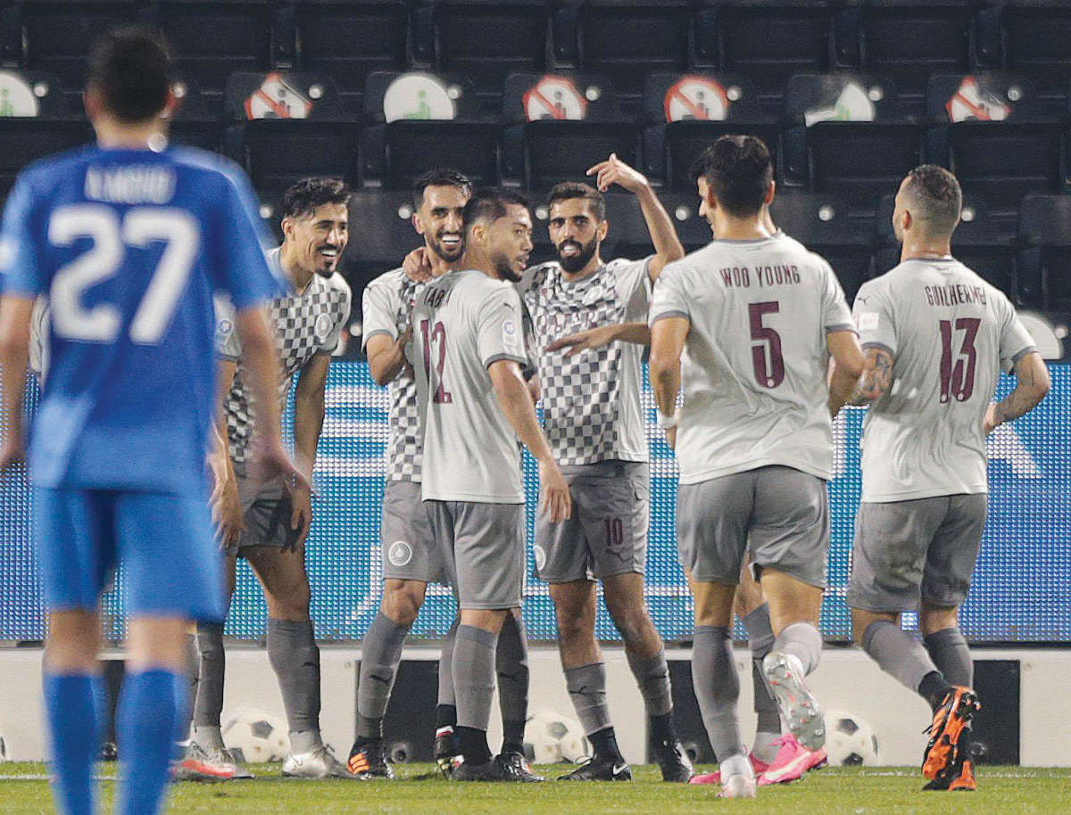 Al Sadd star Hassan Al Haydos (fourth left) celebates with goal-scorer Rodrigo Tabata (third left) and team mates during their team's 5-0 win over Al Kharaitiyat at Jassim Bin Hamad Stadium yesterday. QNB Stars League points leaders Al Sadd won 5-0. 