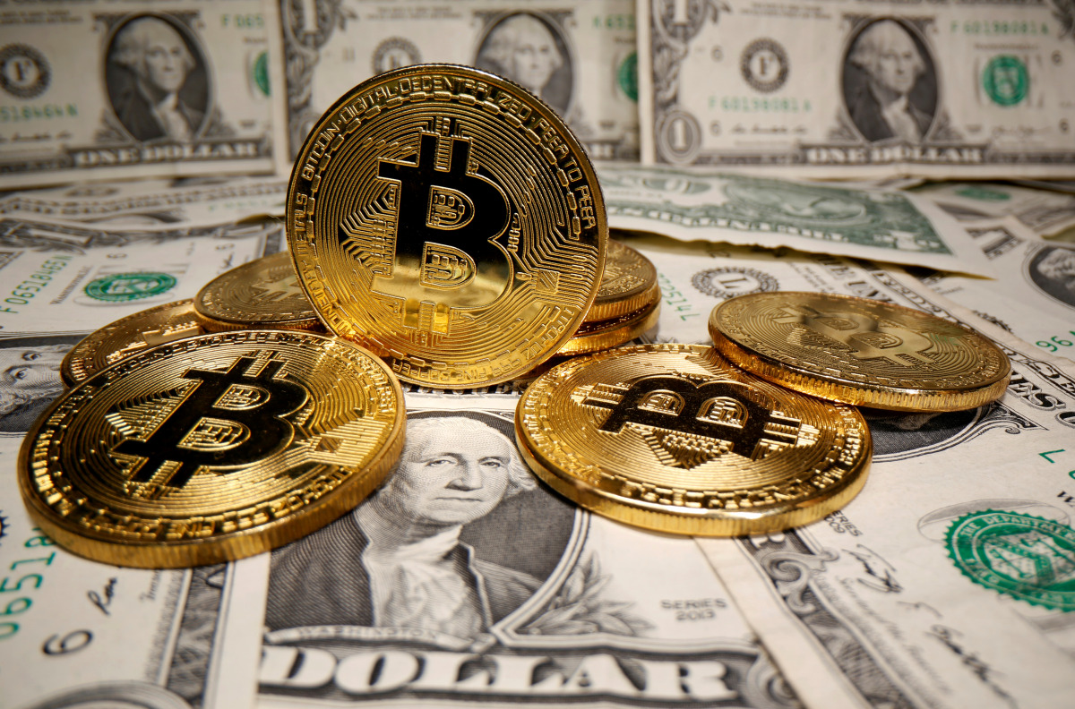 FILE PHOTO: Representations of virtual currency bitcoin are placed on U.S. Dollar banknotes in this illustration taken May 26, 2020. REUTERS/Dado Ruvic/Illustration/File Photo
