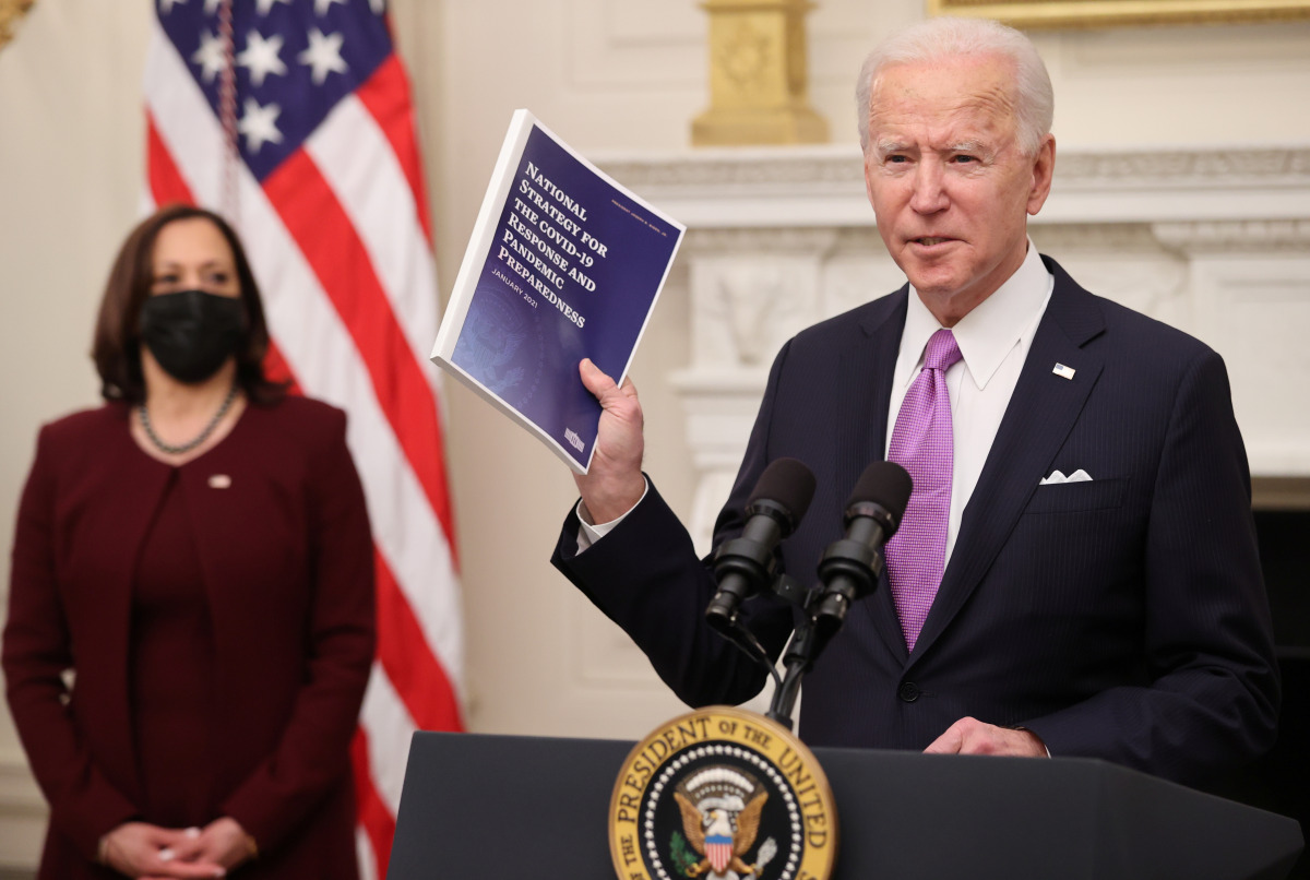 U.S. President Joe Biden speaks about his administration's plans to fight the coronavirus disease (COVID-19) pandemic during a COVID-19 response event as Vice President Kamala Harris listens at the White House in Washington, U.S., January 21, 2021. REUTER