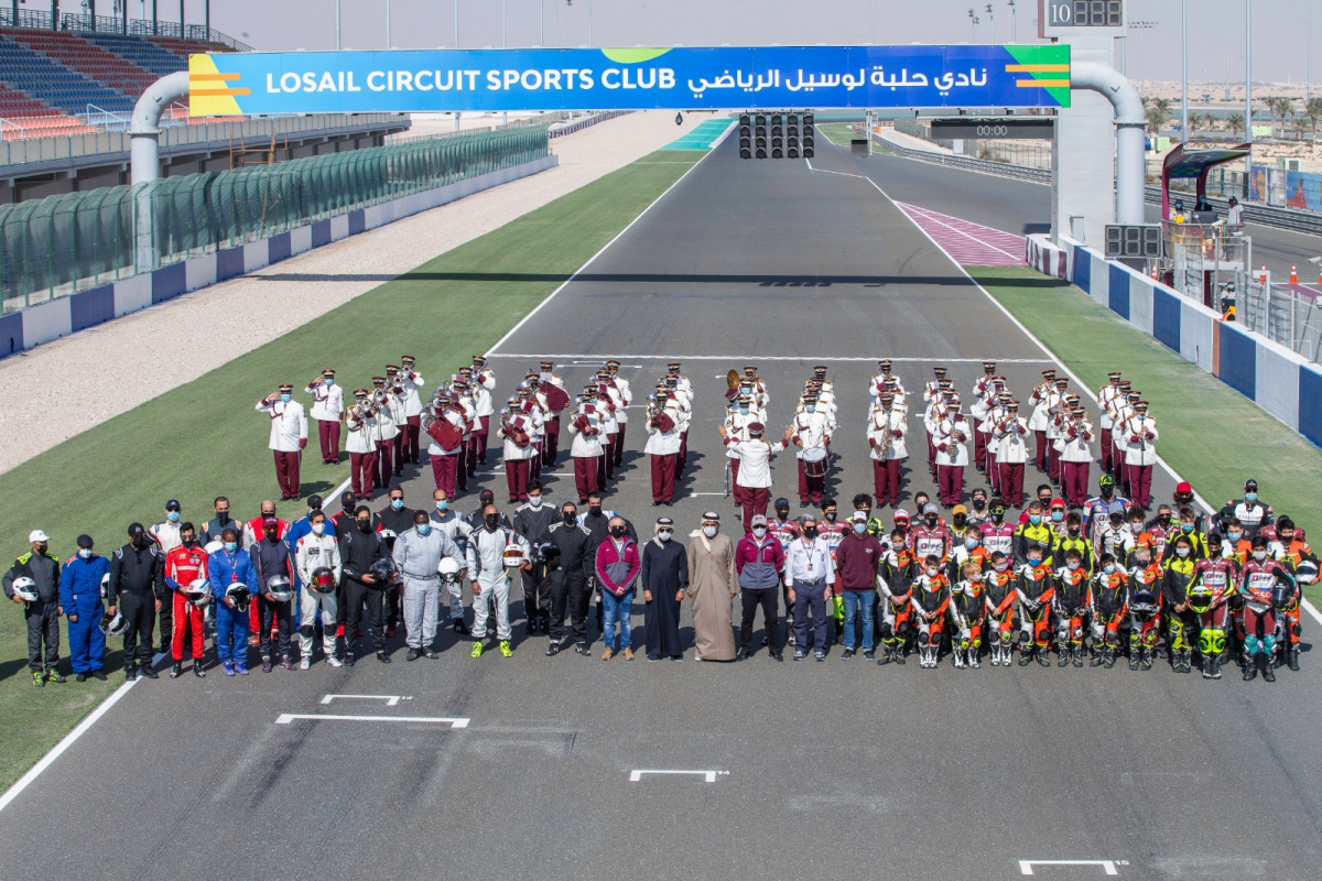The participating riders, drivers and officials posing for a photograph before the opening round of the races at the Losail International Circuit yesterday.

