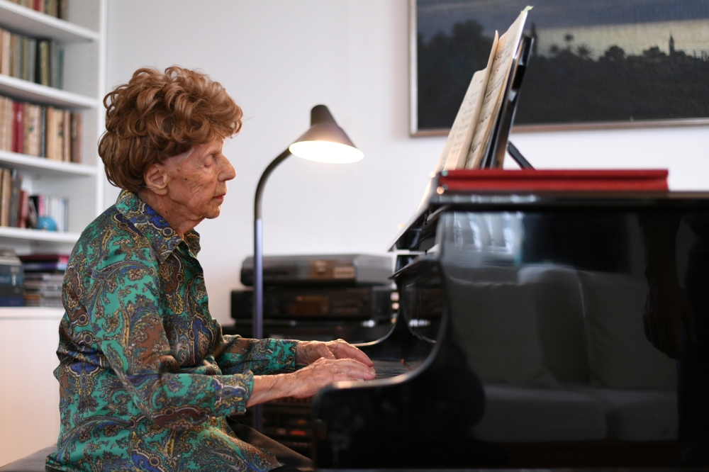 Parisian pianist Colette Maze, 106 years old, plays piano as she poses at her home in Paris, France, February 4, 2021. Maze has been playing the piano since the age of 4, almost one century ago. Today, she is working on yet another album, as performing on