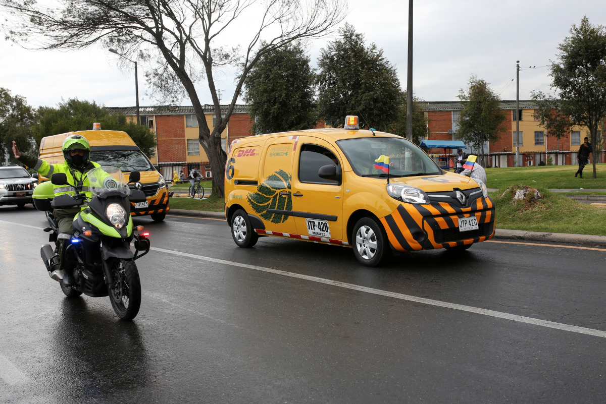 DHL company vans transporting a batch of doses of the Pfizer-BioNTech COVID-19 Vaccine enter the free zone, as the coronavirus disease (COVID-19) outbreak continues, in Bogota, Colombia, February 15, 2021. REUTERS/Luisa Gonzalez
