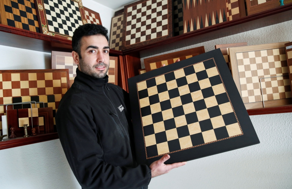 David Ferrer poses with a chessboard at the Rechapados Ferrer factory of which products have appeared in the Netflix series 