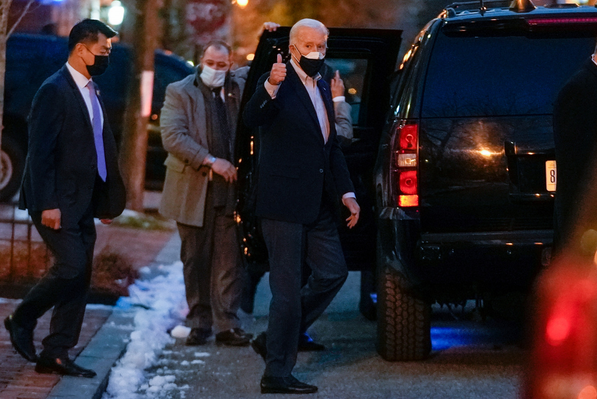 U.S. President Joe Biden gives a thumbs up regarding former Sen. Bob Dole as he walks out from Holy Trinity Catholic Church in the Georgetown neighborhood of Washington, D.C., U.S. February 20, 2021. Biden visited Dole just before going to mass. REUTERS/K