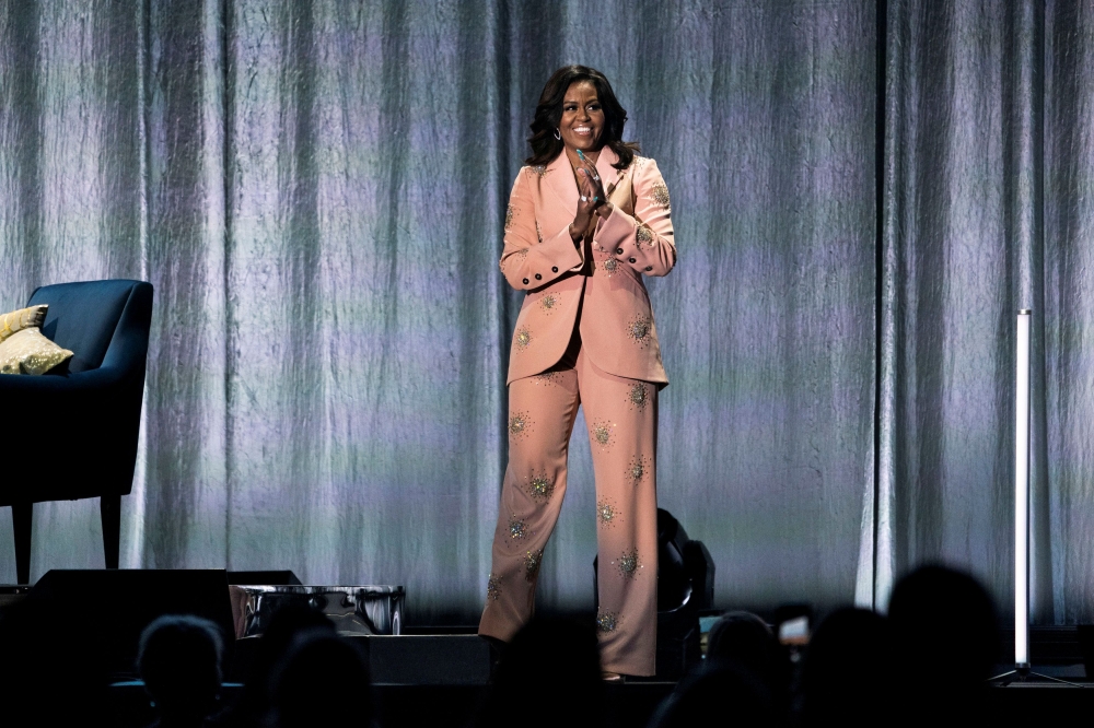 Former first lady Michelle Obama takes the stage at the Royal Arena during her book tour for her biography 