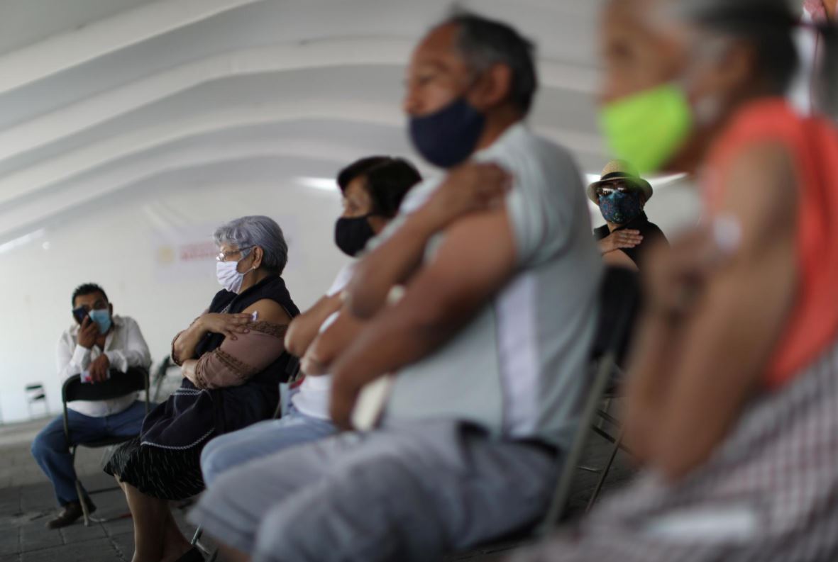Elderly people hold bandages after receive China's Sinovac Biotech vaccine against the coronavirus disease (COVID-19) during the mass vaccination program for the elderly people in Mexico City, Mexico March 25, 2021. REUTERS/Edgard Garrido