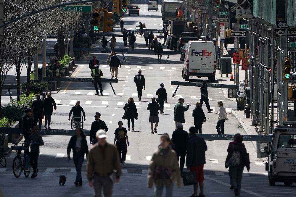 FILE PHOTO: People walk on Park Avenue, which was closed to vehicular traffic, during the outbreak of coronavirus disease (COVID-19), in the Manhattan borough of New York City, New York, U.S., March 27, 2020. REUTERS/Carlo Allegri