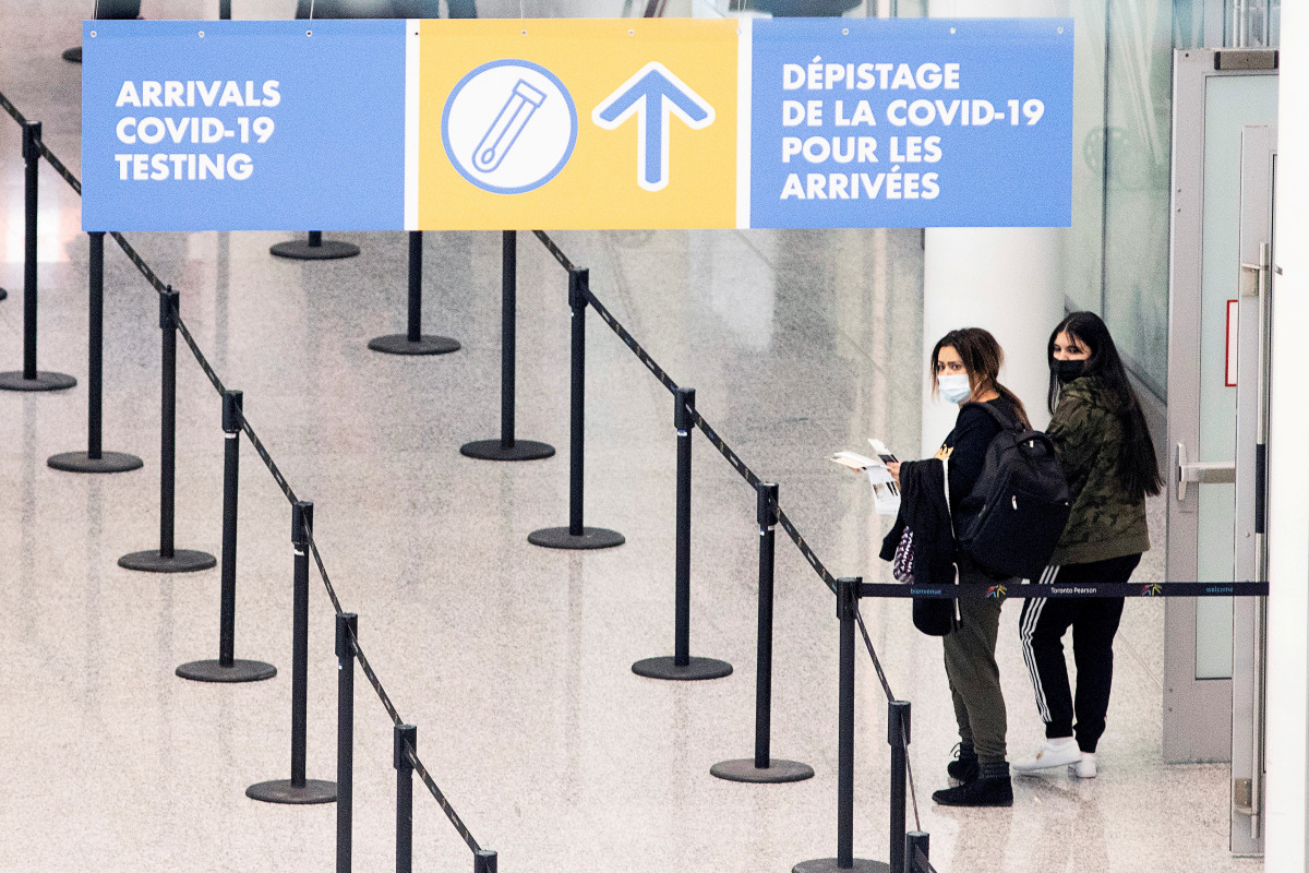 FILE PHOTO: Passengers arrive at Toronto's Pearson airport after mandatory coronavirus disease (COVID-19) testing took effect for international arrivals in Mississauga, Ontario, Canada February 1, 2021. REUTERS/Carlos Osorio/File Photo
