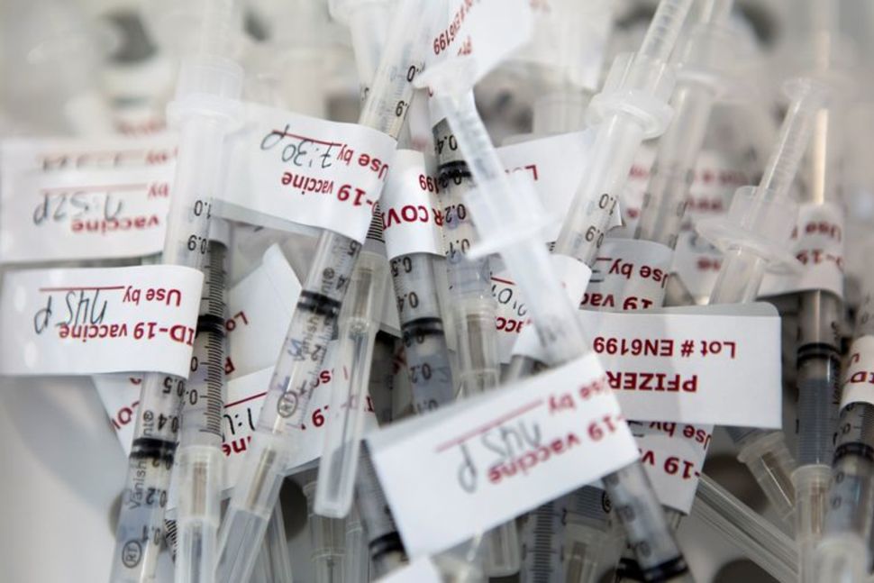 FILE PHOTO: Syringes with doses of Pfizer vaccine against the coronavirus disease (COVID-19) sit in a basket waiting to be administered at Richmond raceway in Richmond, Virginia, U.S., March 4, 2021. REUTERS/Julia Rendleman/File photo Reuters

