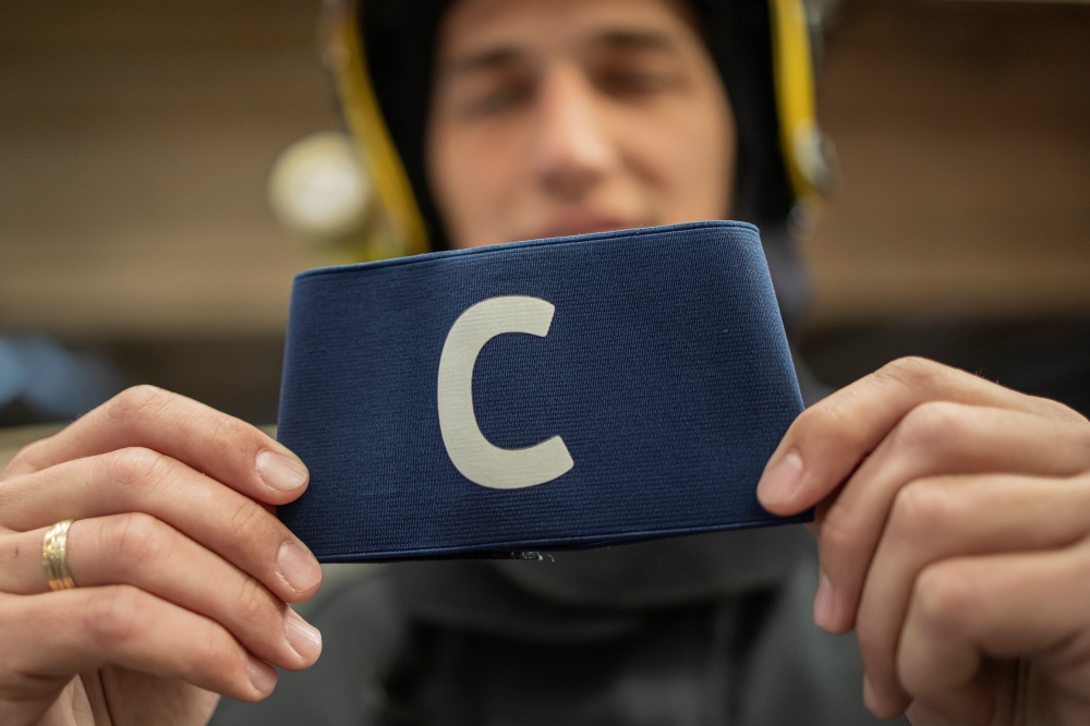 Djordje Vukicevic, duty firefighter, poses with Cristiano Ronaldo's armband which the Portugal captain threw on the pitch after his goal was disallowed in a World Cup qualifier against Serbia, at the Belgrade's firefighting brigade headquaters, Serbia, Ap