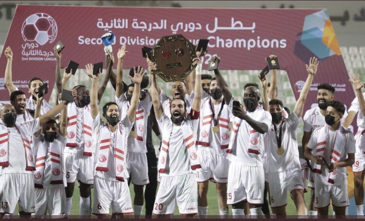 Second Division champions Al Shamal players celebrate with the League trophy.