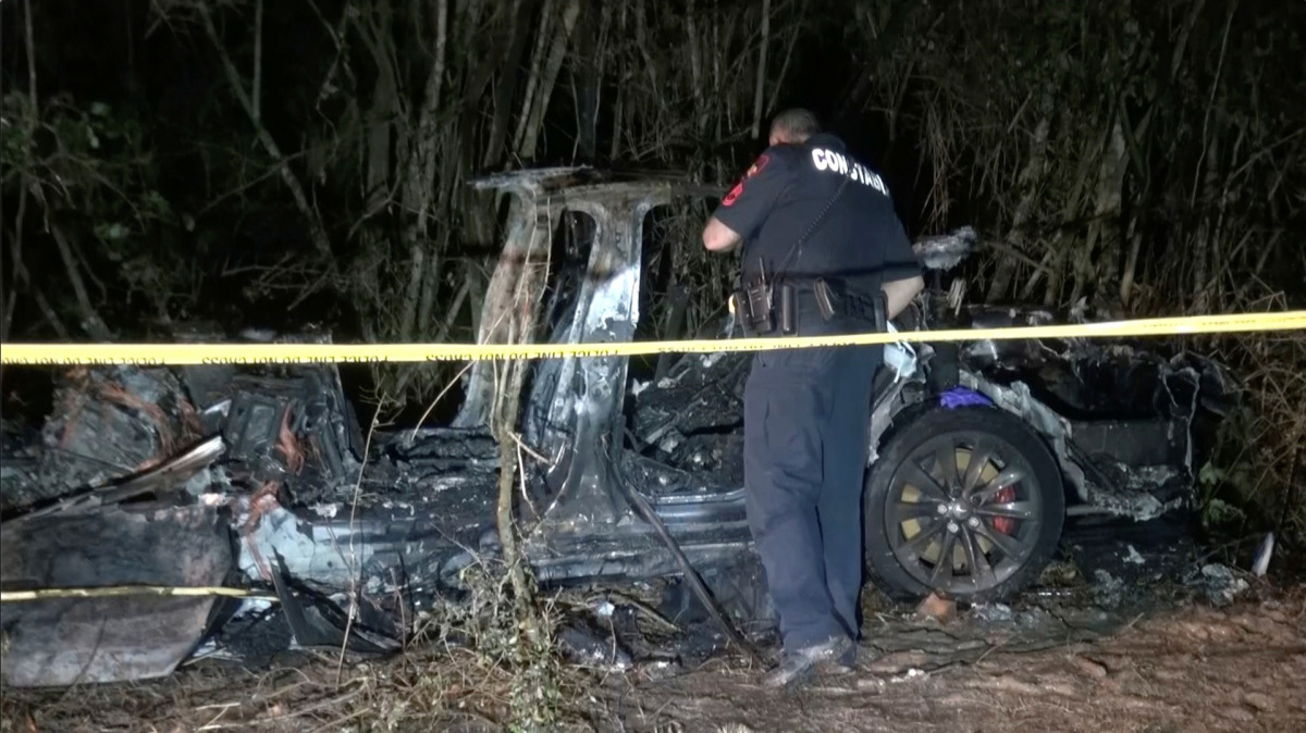 The remains of a Tesla vehicle are seen after it crashed in The Woodlands, Texas, April 17, 2021, in this still image from video obtained via social media. Video taken April 17, 2021. SCOTT J. ENGLE via REUTERS 