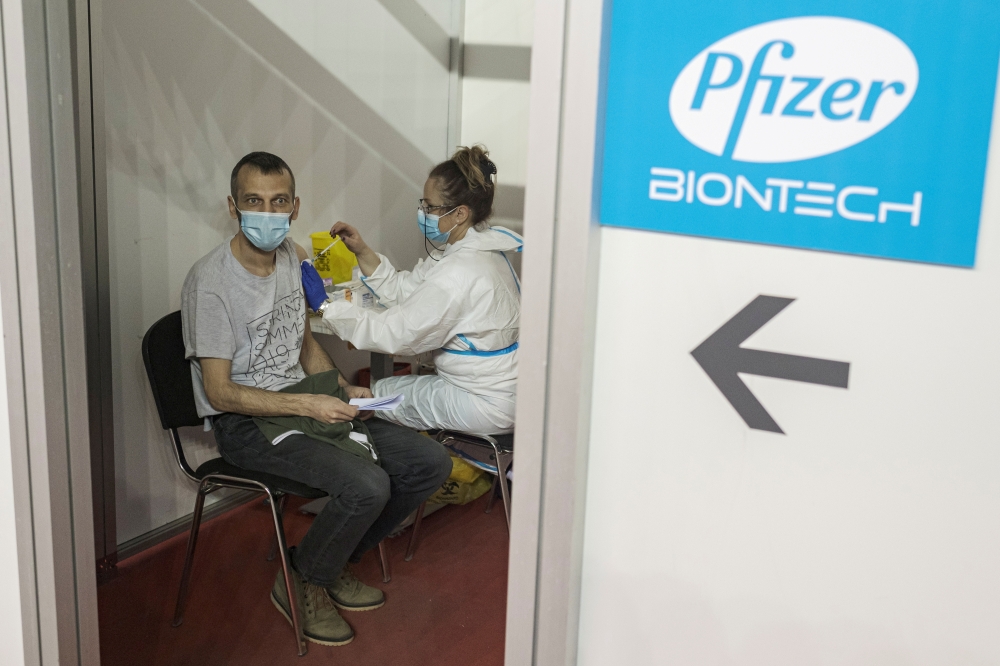 A man receives a second dose of the Pfizer-BioNTech vaccine against the coronavirus disease (COVID-19) at the hall three of the Belgrade Fair, in Belgrade, Serbia, April 13, 2021. REUTERS/Marko Djurica/File Photo