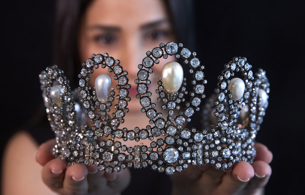 A staff holds a diamond and pearl tiara passed down through generations of the Italian royal family during a preview at Sotheby's before their auction in Geneva, Switzerland, May 6, 2021. REUTERS/Denis Balibouse