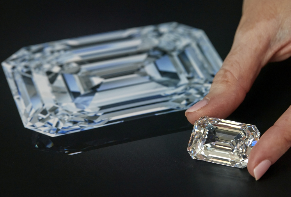 A staff holds a D colour, internally flawless rectangular step-cut diamond of 100.94 carats during a preview at Christie's before its auction sale in Geneva, Switzerland, May 7, 2021. REUTERS/Denis Balibouse