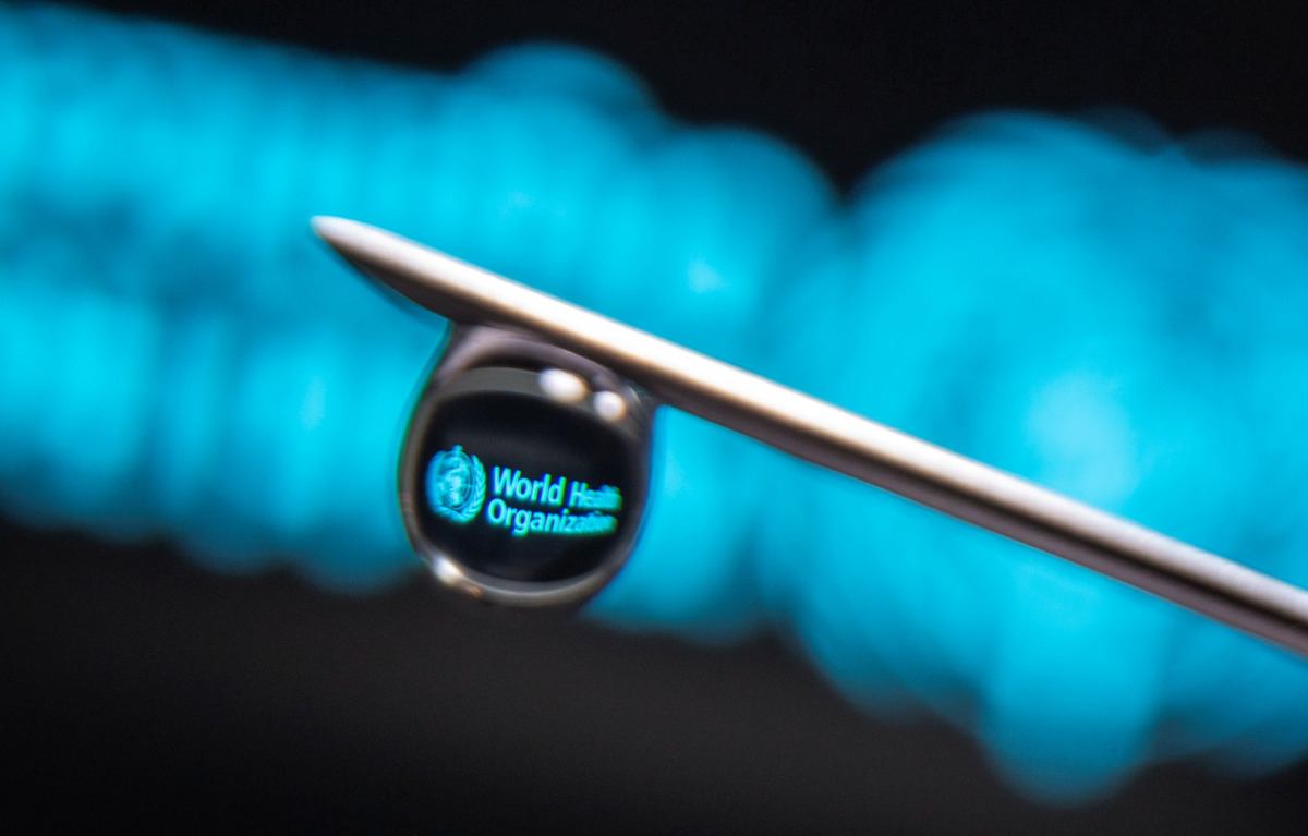 FILE PHOTO: World Health Organization logo is reflected in a drop on a syringe needle in this illustration photo taken March 16, 2021. REUTERS/Dado Ruvic/Illustration/File Photo

