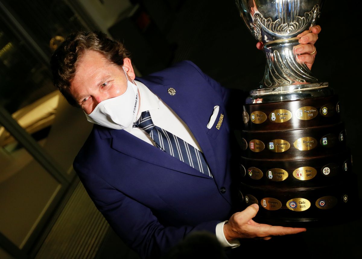 File photo of Alejandro Dominguez, president of CONMEBOL, holding the Copa America trophy. Reuters